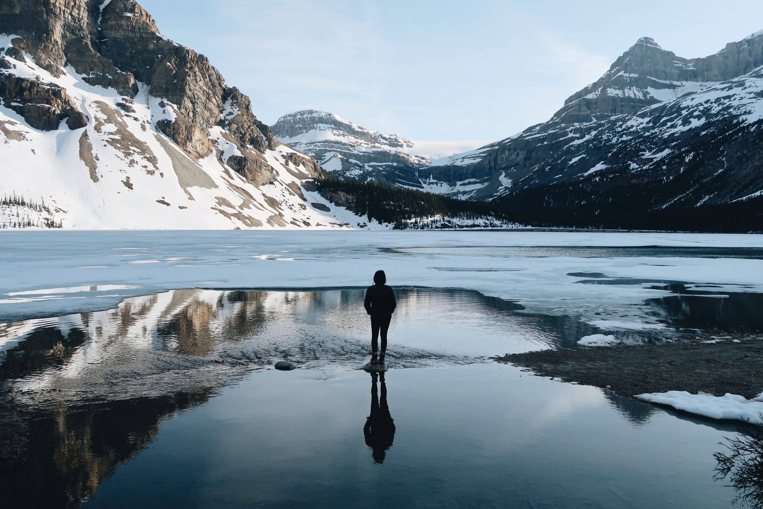 Person standing in front of mountains - key takeaways from Essentialism - how to live an essentialist life
