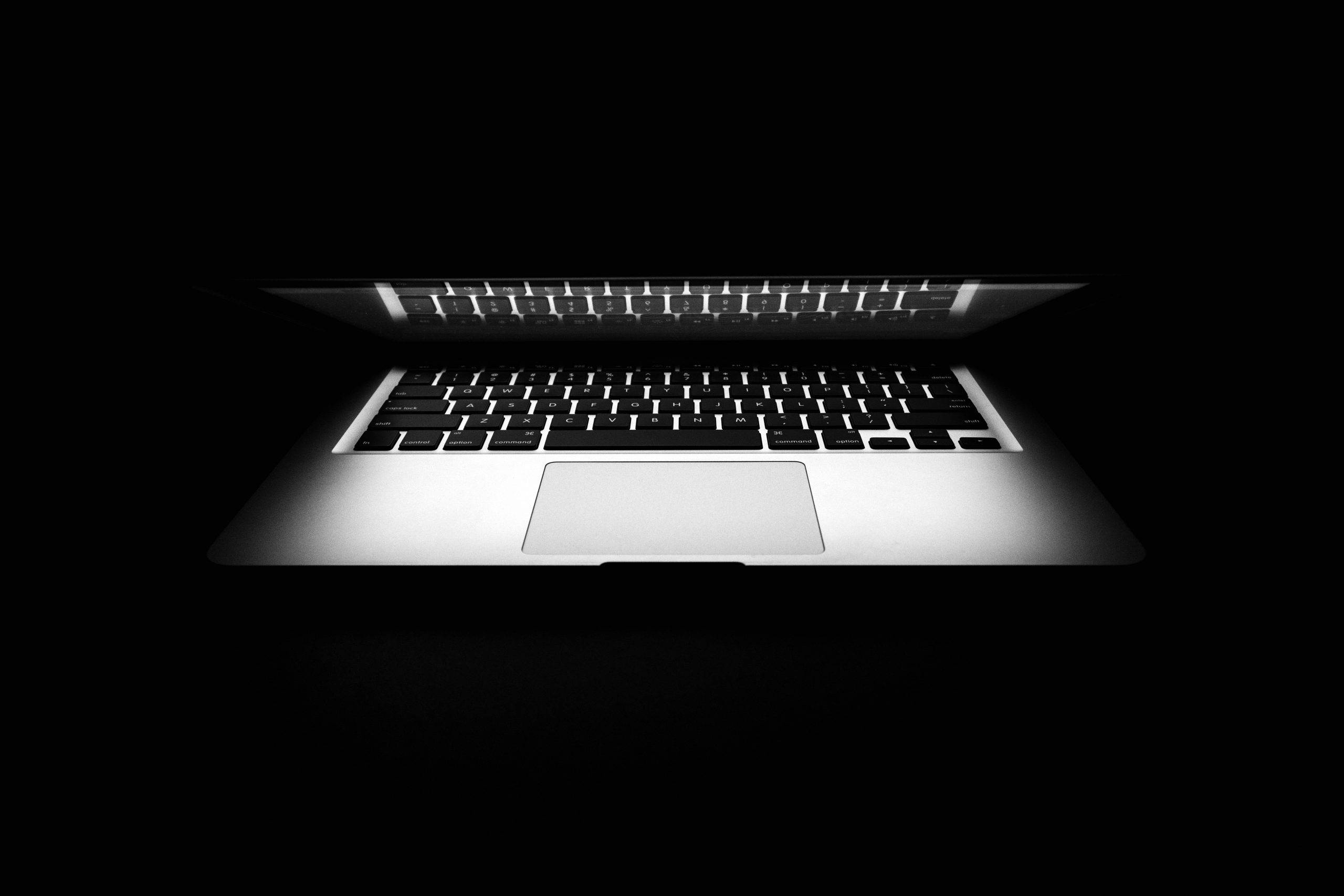 7 Ways to cut out distractions in everyday life - laptop half closed with black background
