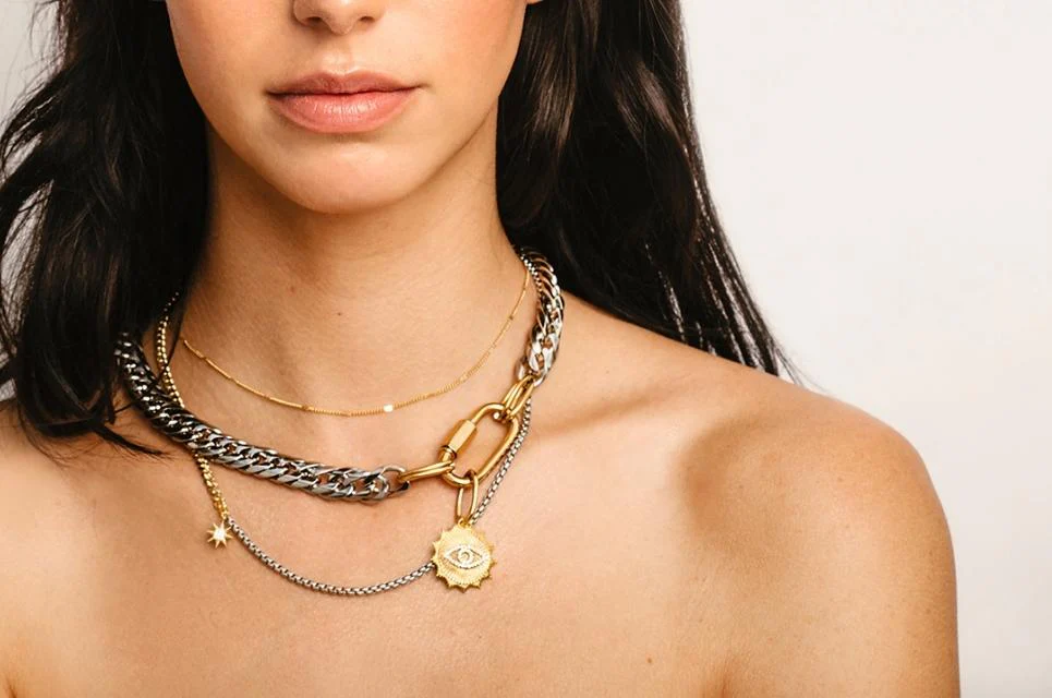 Close up of a Woman wearing different Artizan Necklaces featuring Evil Eye Charm