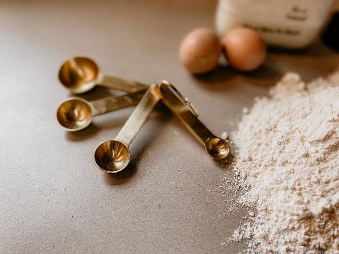 Measuring Spoons Beside Flour